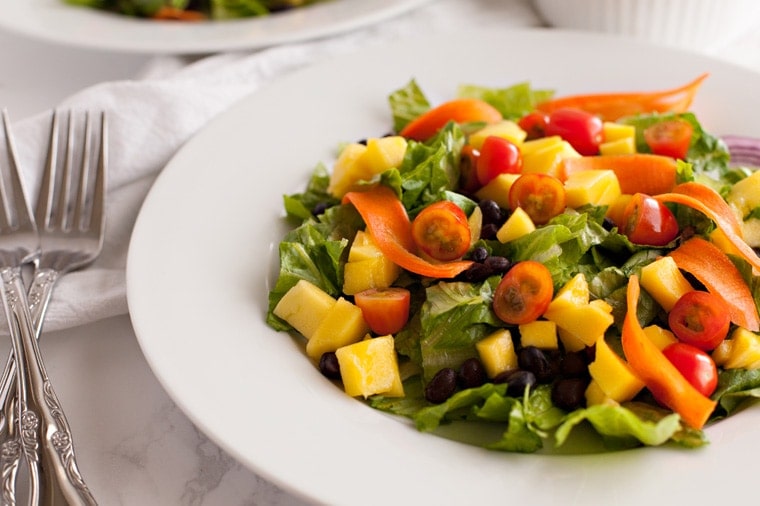 close up of black bean and mango salad in a salad bowl