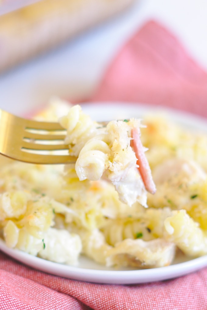 Fork with a bite of chicken cordon bleu casserole