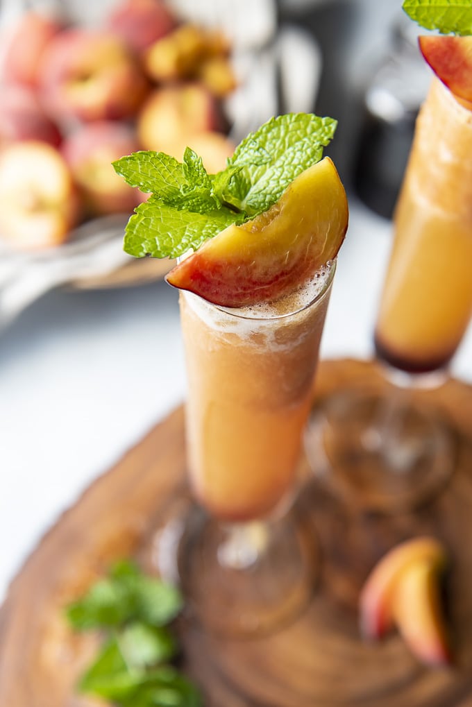Frozen Peach Bellini topped with a peach slices and mint