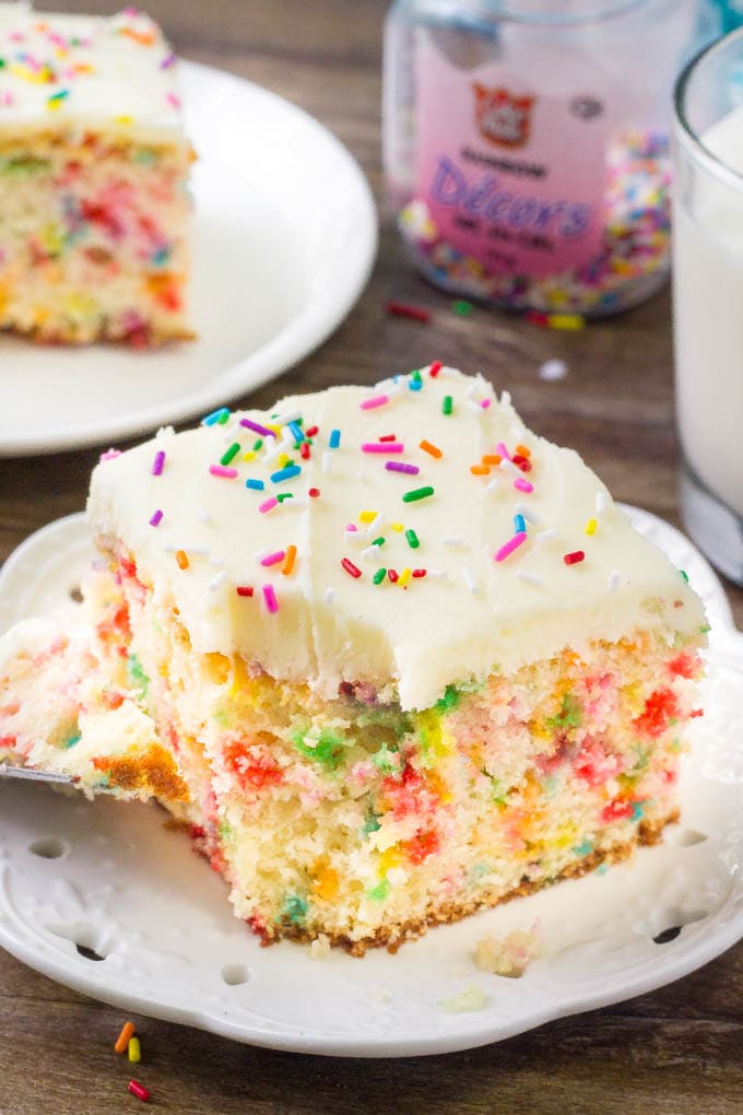 Moist, tender funfetti sheet cake is loaded with sprinkles and topped with fluffy vanilla frosting. 