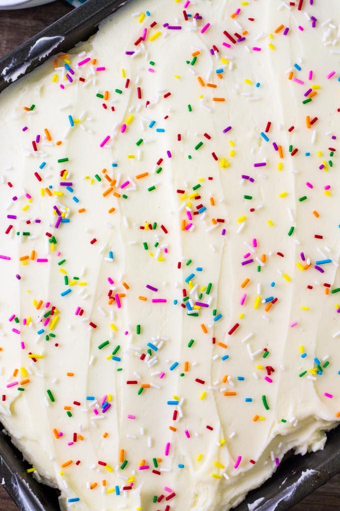 Funfetti sheet cake is made in a 9x13 inch pan and decorated with tons of sprinkles