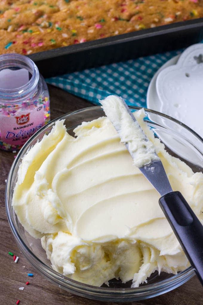 Creamy, fluffy vanilla frsoting is the perfect topping for funfetti cake. 