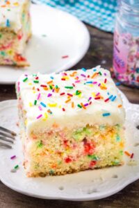 A slice of funfetti sheet cake with vanilla frosting makes for the perfect birthday cake recipe.