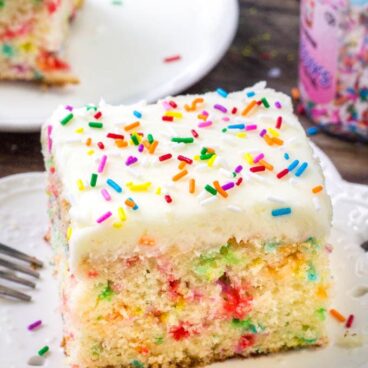 A slice of funfetti sheet cake with vanilla frosting makes for the perfect birthday cake recipe.