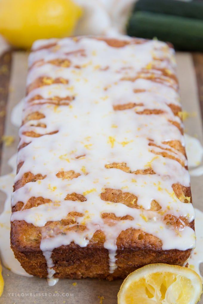 a loaf of lemon zucchini bread with a sweet lemon glaze and lemon zest