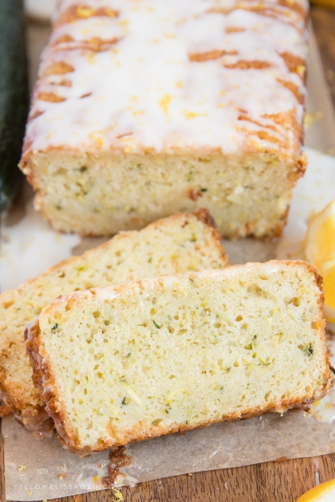 a loaf of lemon zucchini bread with two slices cut