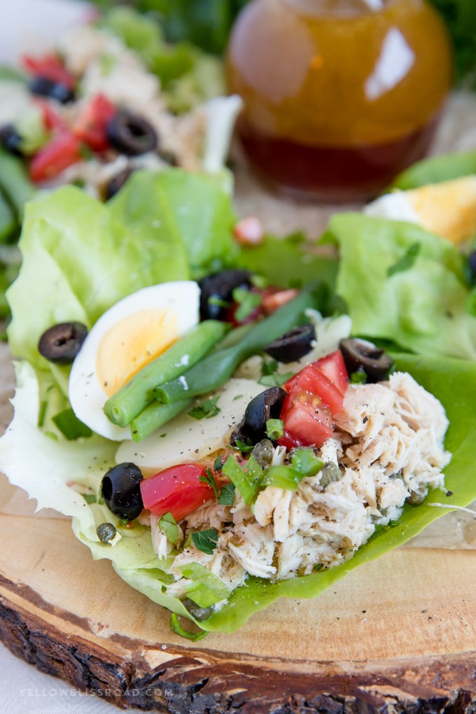 Nicoise Salad Lettuce Wraps close up with eggs, green beans, potatoes, tomatoes and olives.