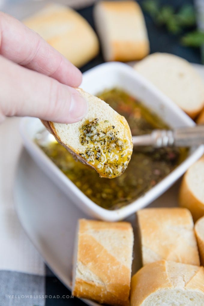 a slice of french bread dipped in garlic & herb olive oil bread dip