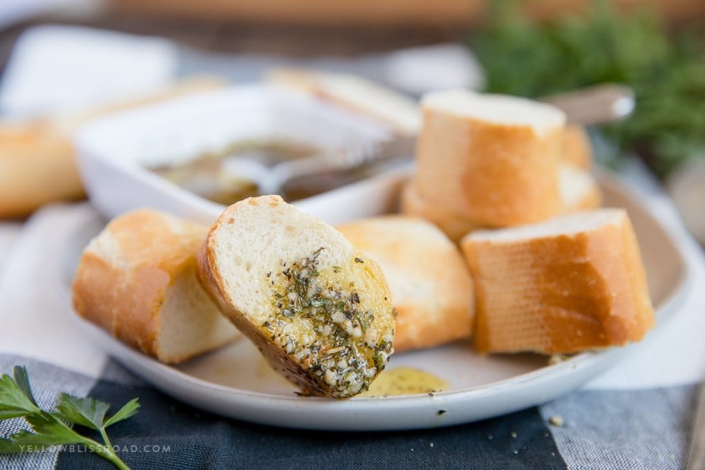 a slice of bread coated in olive oil with herbs and garlic