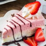 A close up of a slice of Strawberry Ice Cream Cake