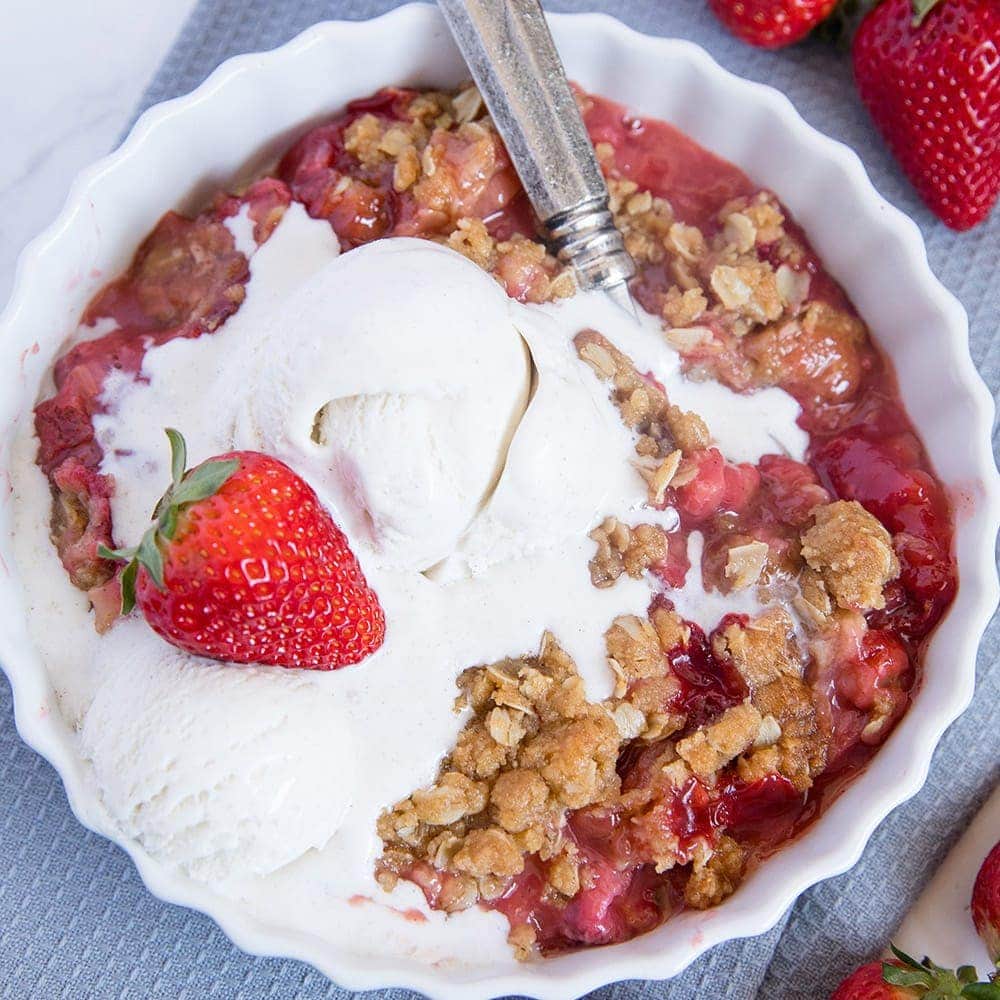 A dish of Strawberry Rhubarb Crisp with ice cream