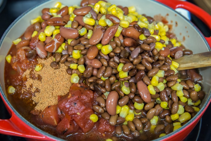 a pot full of black beans, kidney beans, corn, tomatoes and ground turkey