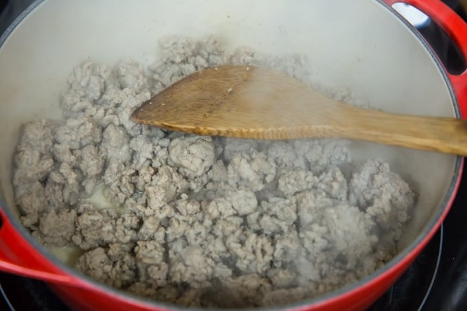 a pot full of cooked ground turkey with a wooden spatula