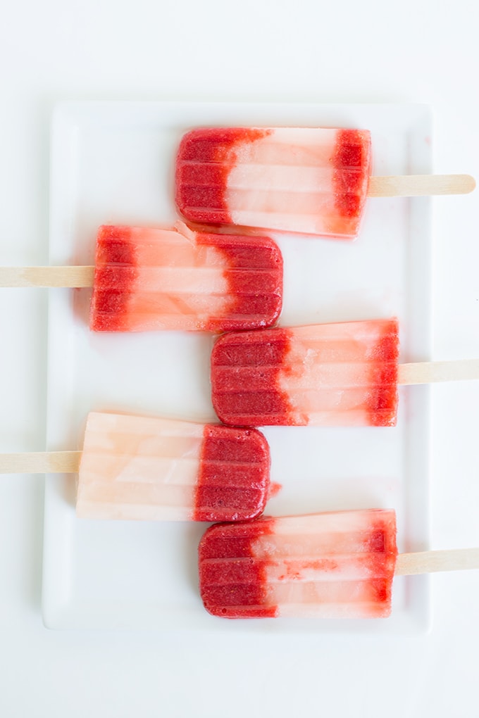 strawberry lemonade popsicles laid out on a serving plate
