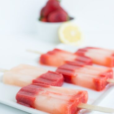 This strawberry lemonade popsicle recipe is so bright and refreshing! It's tangy, sweet, and the perfect summer dessert to cool off with!