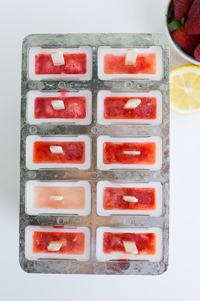 popsicle mold filled with strawberry lemonade popsicle mix