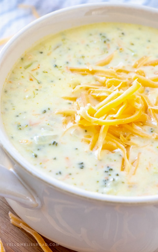 Broccoli Cheese soup in a bowl with shredded cheese on top.