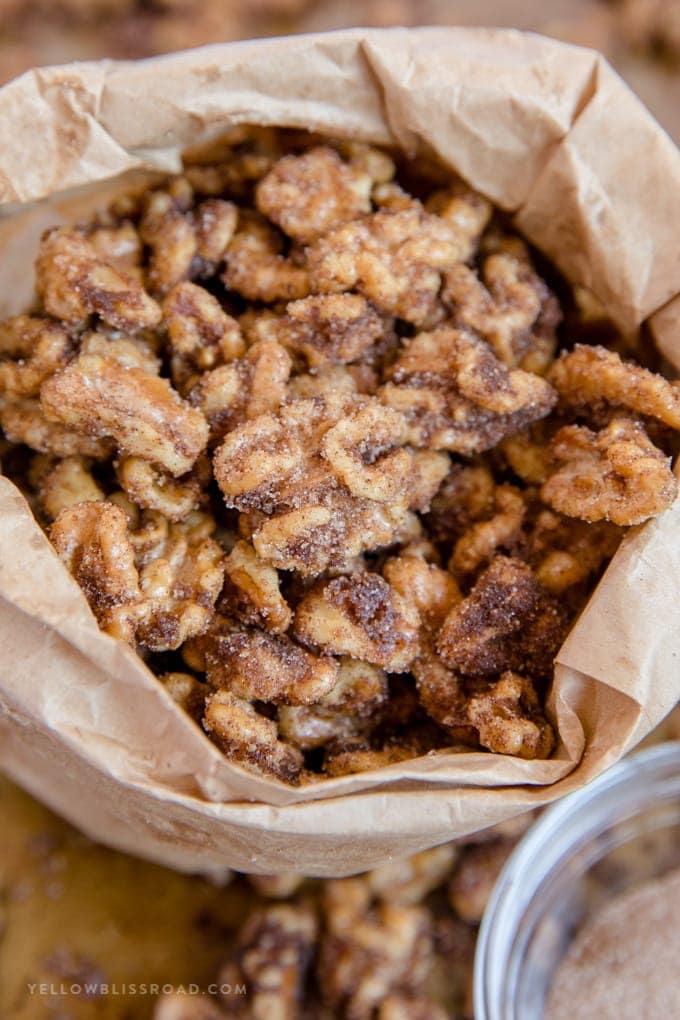 Churro walnuts with cinnamon sugar in a brown paper bag