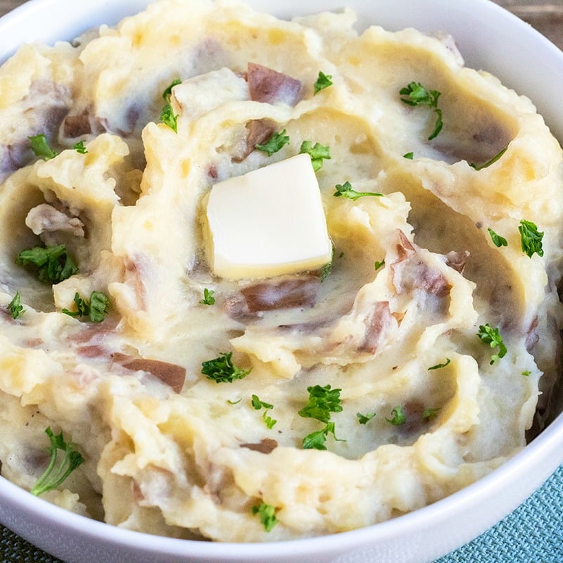 A bowl of mashed potatoes with butter