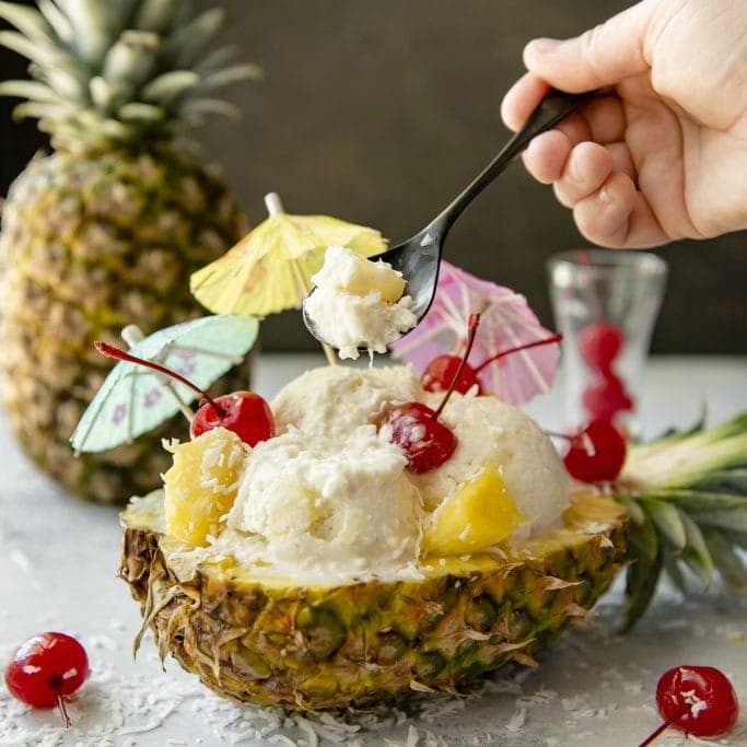 A half pineapple filled with ice cream