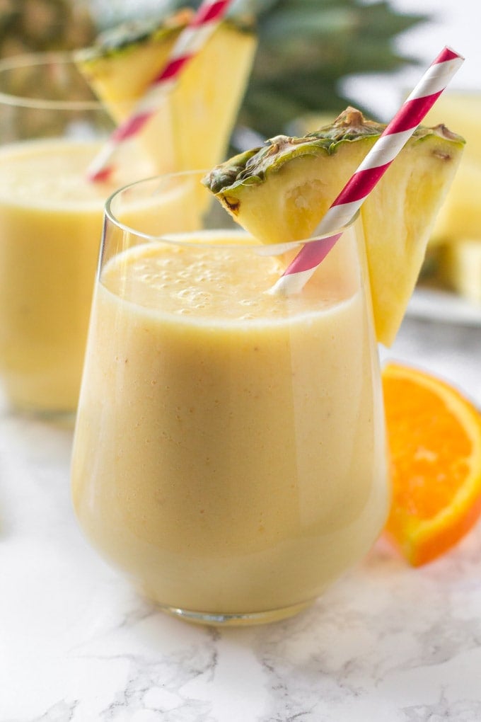 This pineapple smoothie tastes like a tropical paradise in a glass. So refreshing and deliciously sweet, it's the perfect smoothie recipe to start your day! pineapple smoothie in a glass with a straw