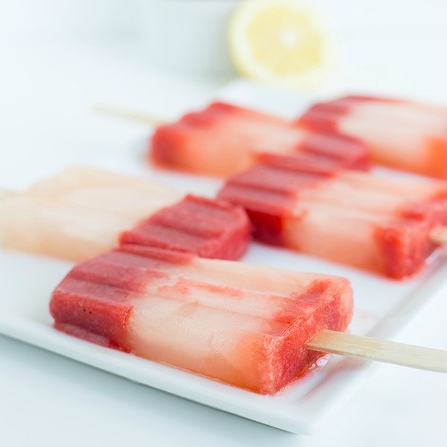 A close up of strawberry popsicles