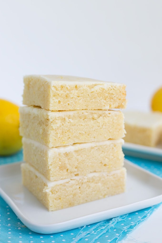 Lemon brownies stacked up on a plate