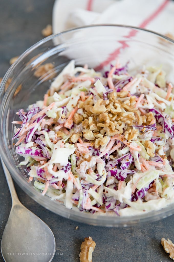 Creamy Walnut Coleslaw recipe in a clear glass bowl