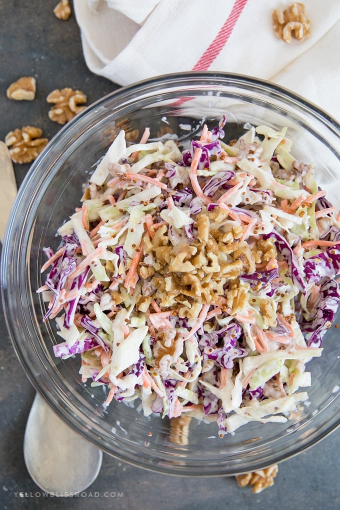 Creamy Walnut Coleslaw in a bowl topped with walnuts