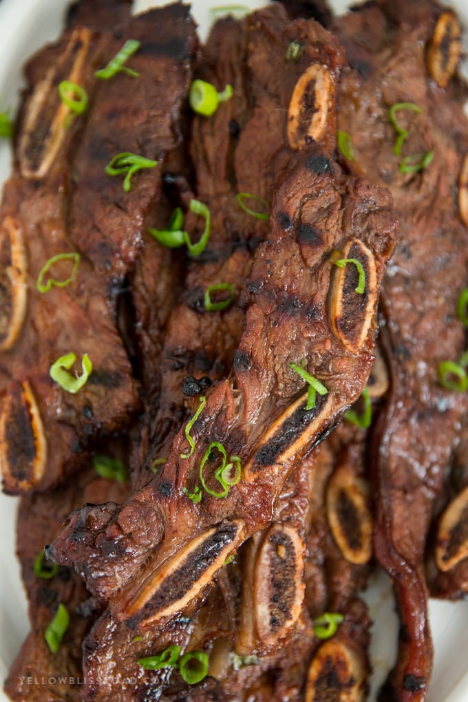 Grilled Korean Short Ribs are so tender and full of flavor! Marinated in a tangy Kalbi style marinade for hours, this juicy short rib recipe is a sure hit! korean short ribs up close