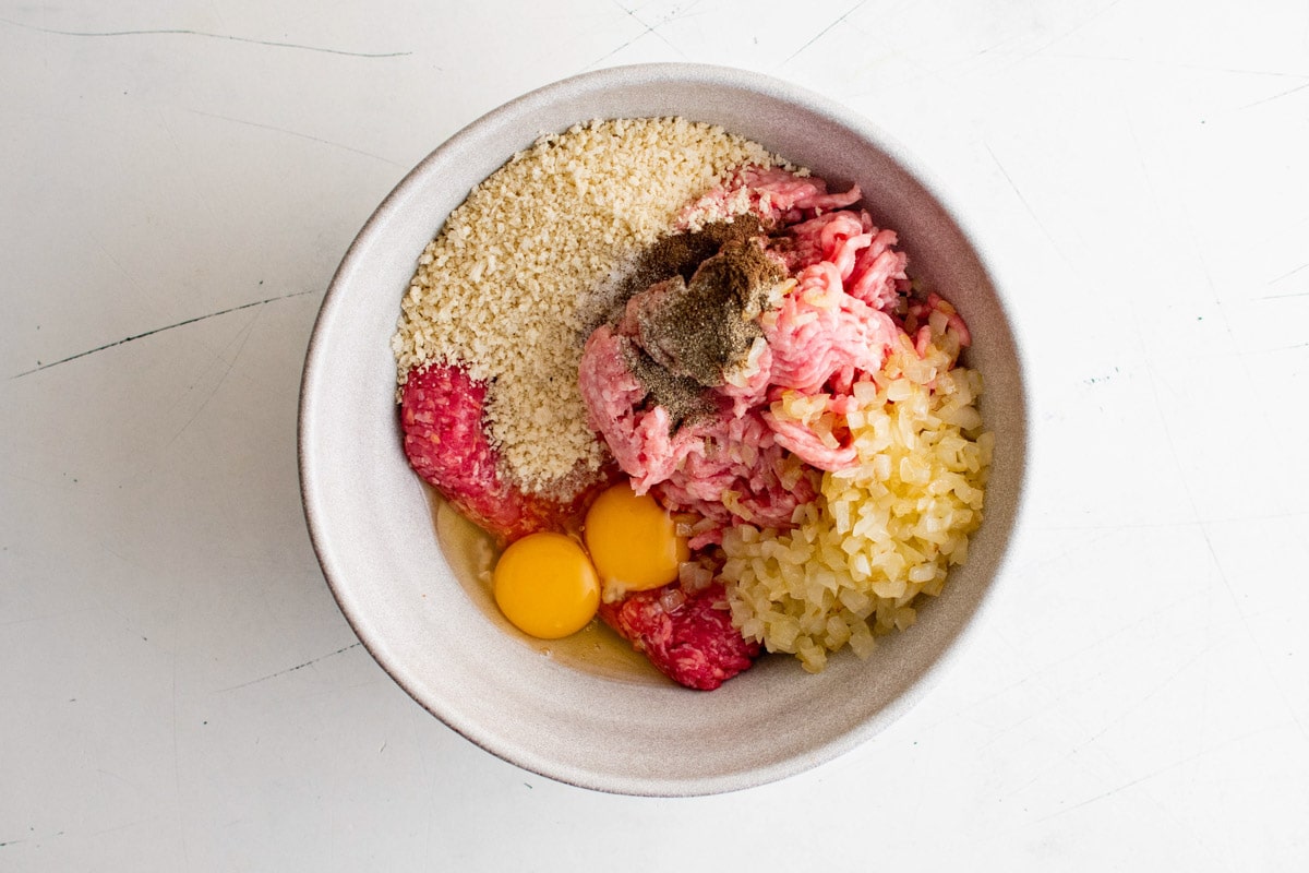 Ground meat, eggs, breadcrums and seasonings in a large bowl.