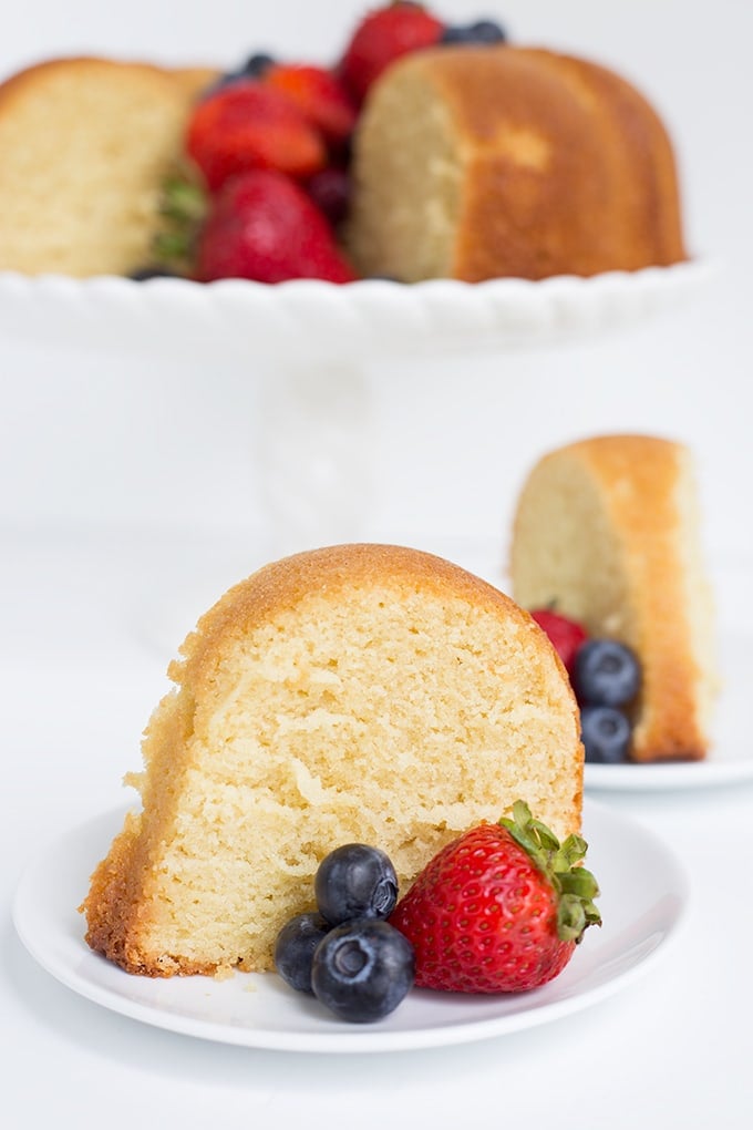 slice of pound cake on a dessert plate with fresh berries