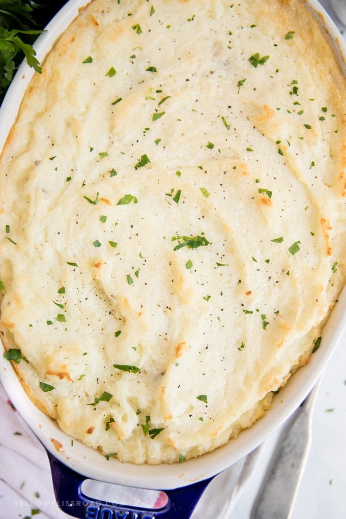 An overhead shot of the best mashed potatoes baked in a large dish