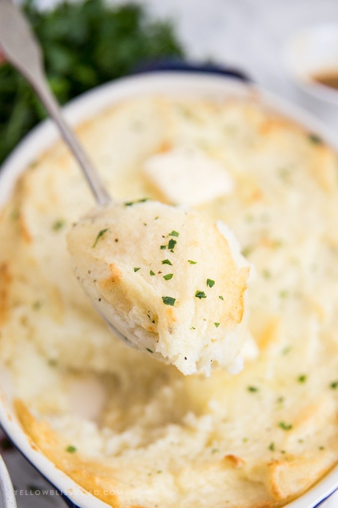 A close up of Mashed Potatoes on a large spoon. 