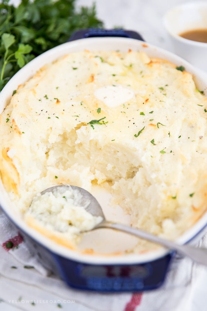 Fluffy, creamy and so flavorful this Make Ahead Mashed Potatoes recipe is a simple and easy side dish that will be the star of any meal. A half eaten pan of make ahead best mashed potatoes.