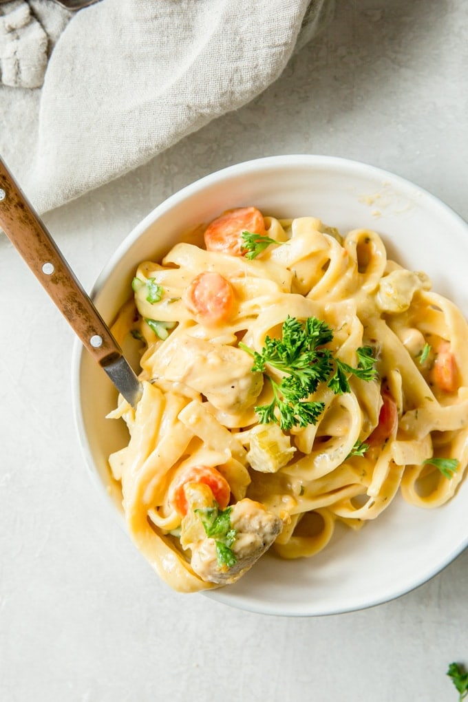 An overhead shot of a bowl filled with a serving of creamy one pot chicken and noodles