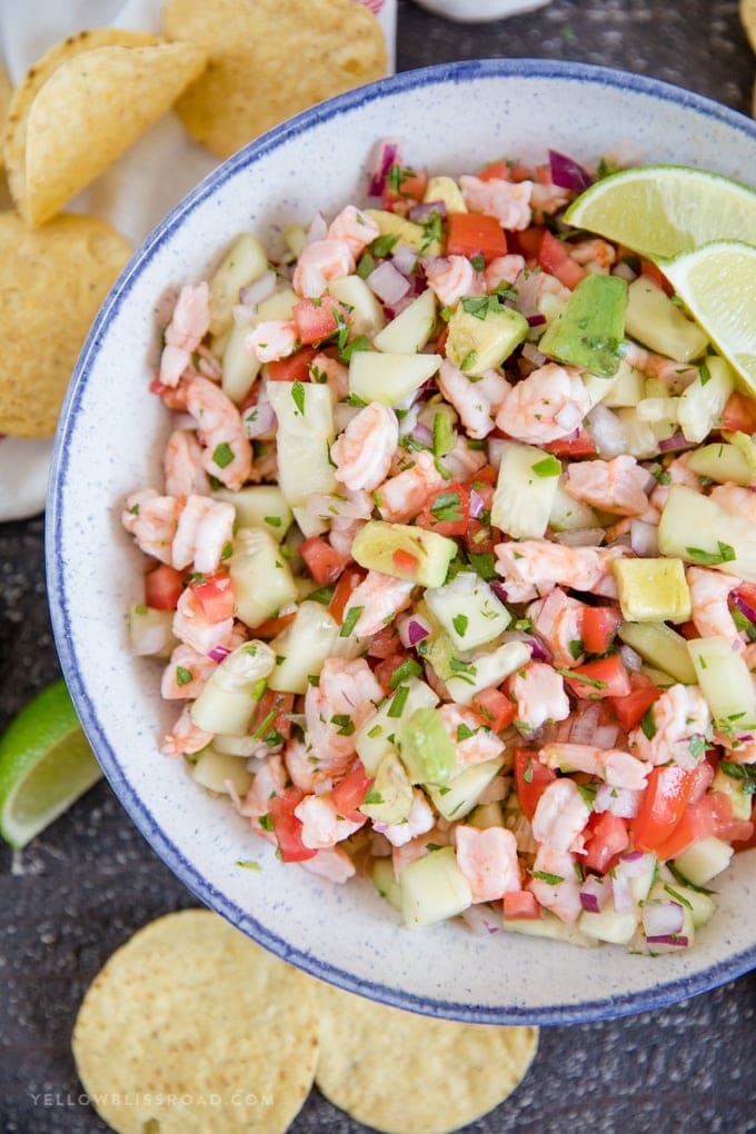 Shrimp Ceviche in a large bowl with lime and tortilla chips.