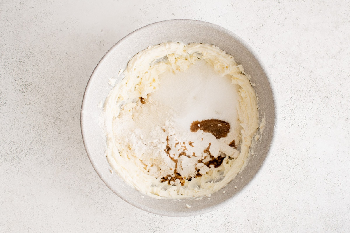 Cream cheese, sugar and vanilla in a bowl.