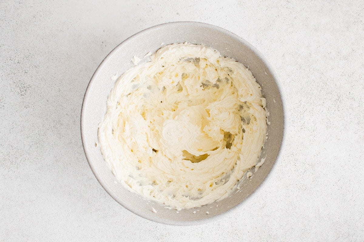 Cream cheese beaten in a bowl.