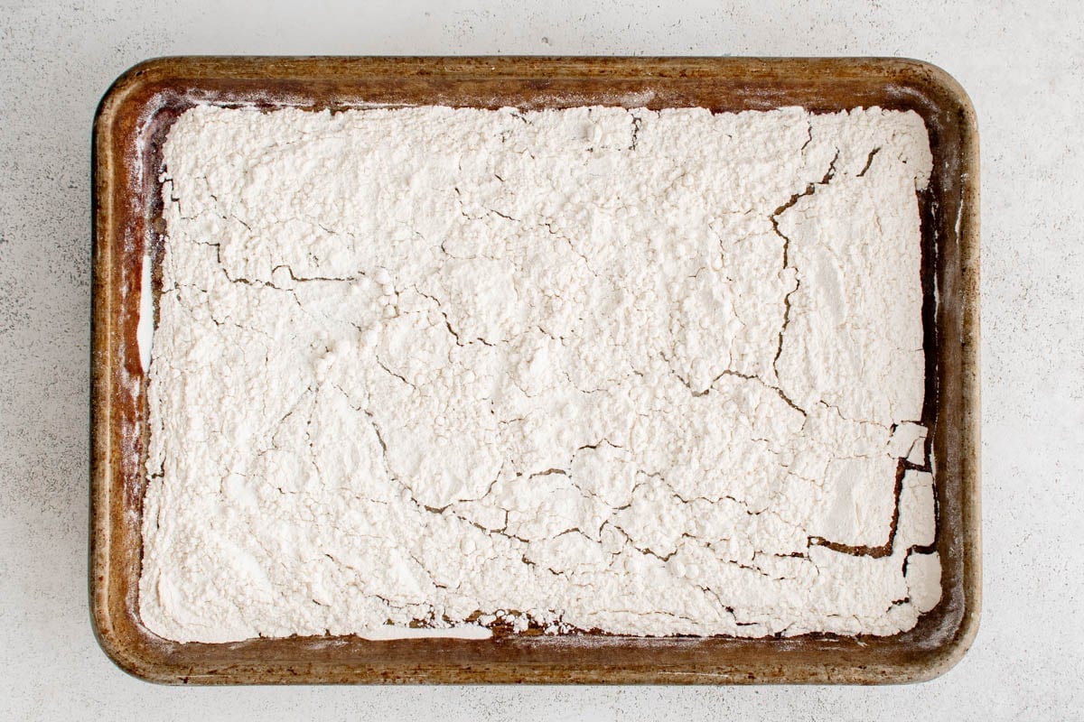 Flour on a baking sheet.