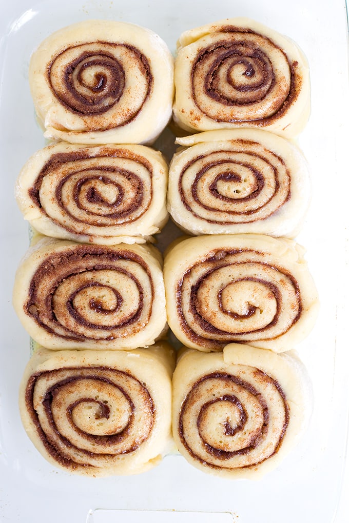 These homemade cinnamon rolls are so soft & gooey and baked to a golden brown perfection before being smothered in cream cheese frosting. I can't imagine breakfast without them! homemade cinnamon rolls in a pan ready to be baked