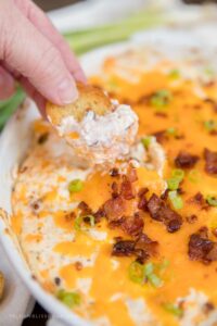 Social media image of cracker being dipped into Chicken Crack Dip
