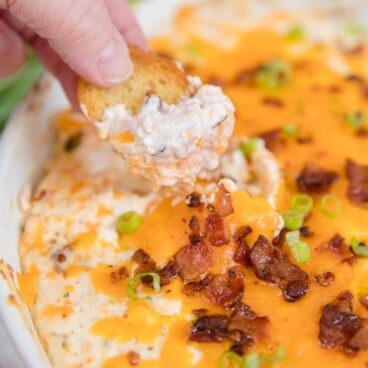 Social media image of cracker being dipped into Chicken Crack Dip