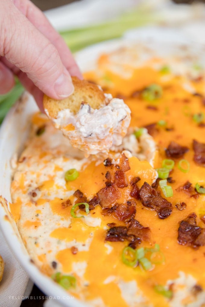 Chicken Crack Dip scooped with a piece of toasted bread.