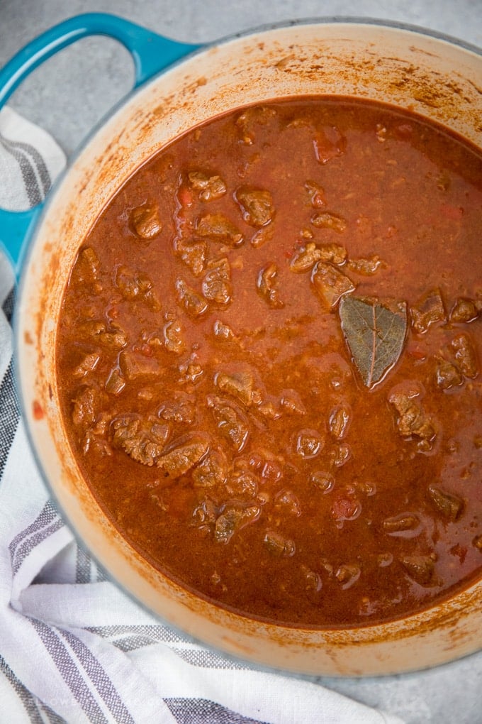 A pot of Authentic Hungarian Goulash - chunks of beef in a tomato beef broth.