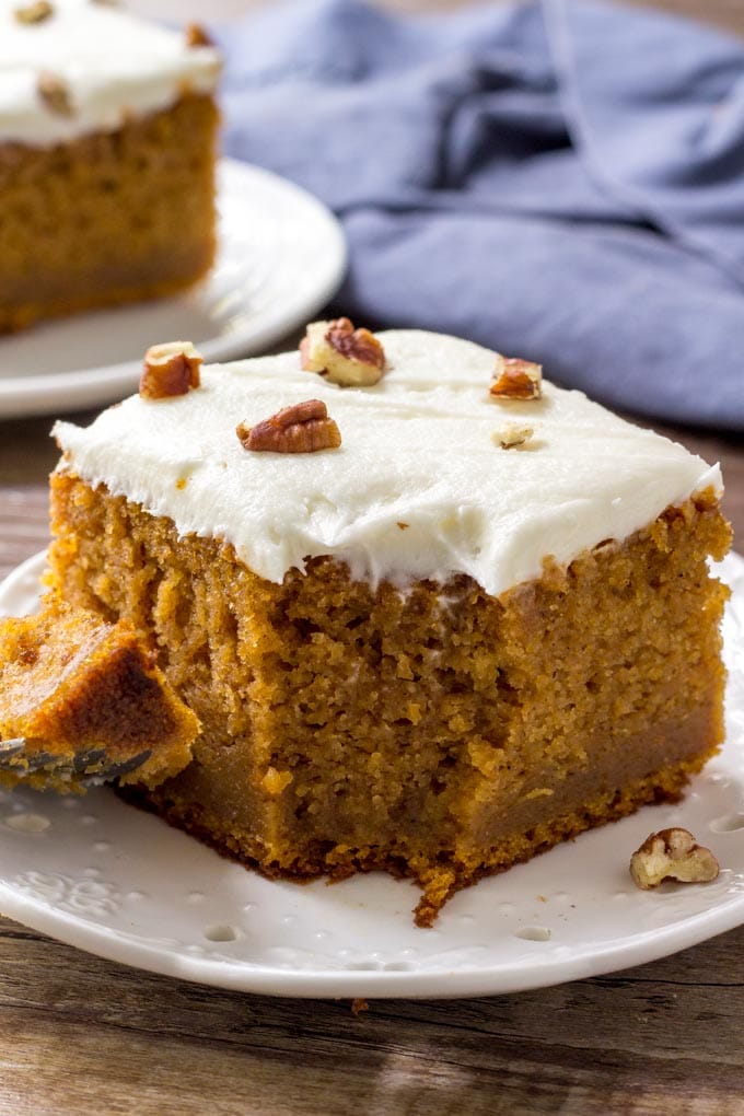 A large slice of sweet potato cake with a bite eaten out of it. 