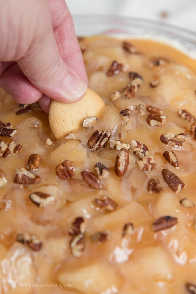 A vanilla wafer dipped in Caramel Apple Pie Cheesecake Dip.