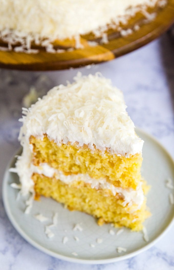 a slice of coconut cake on a dessert plate