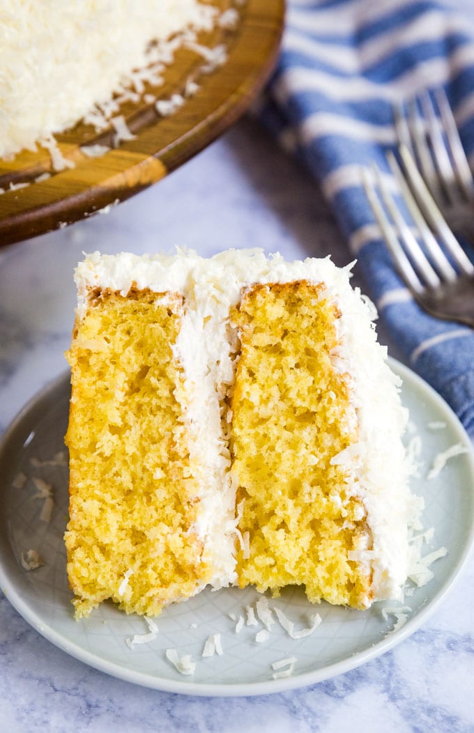 slice of coconut cake on its side on a plate