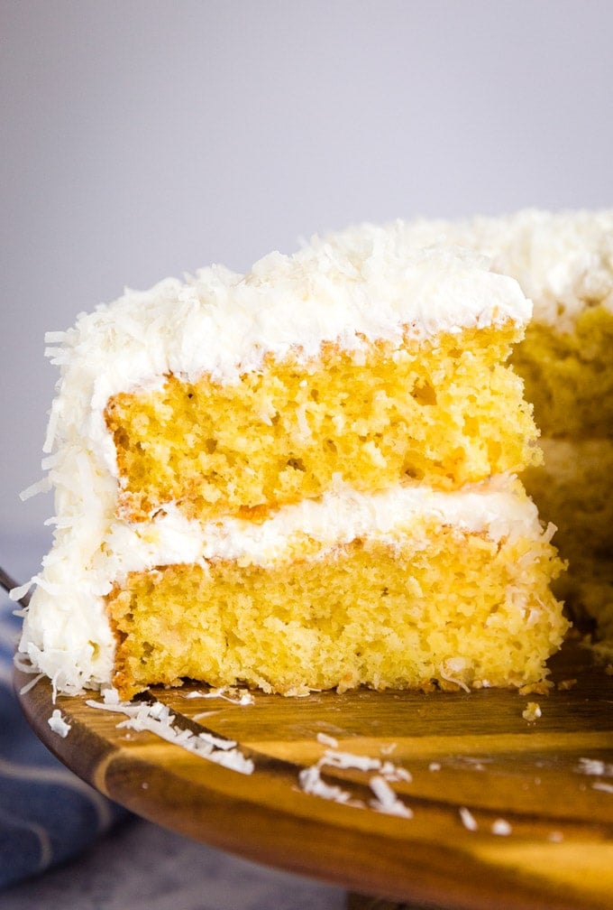 coconut cake slice being pulled away from the rest of the cake